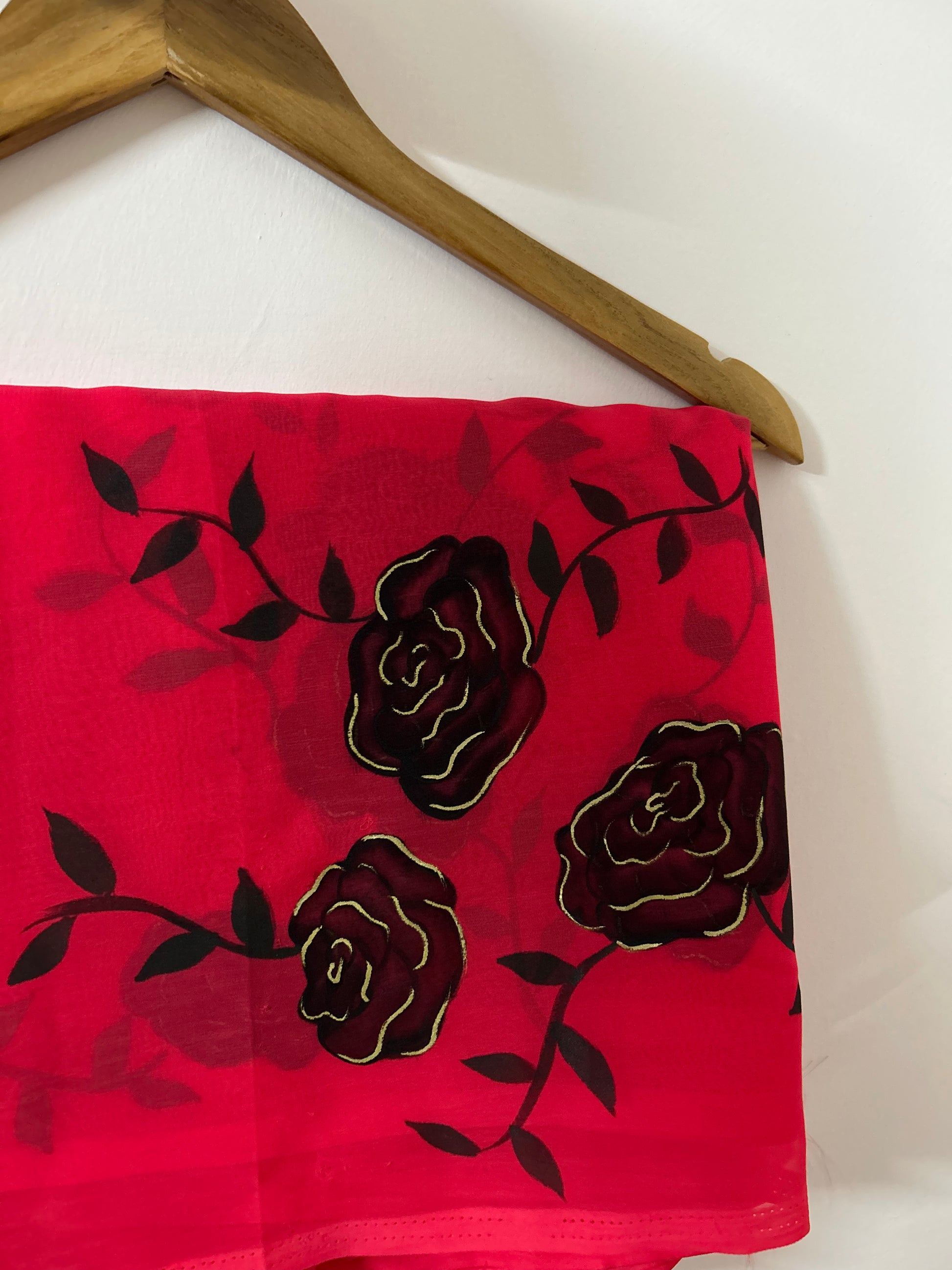 red handpainted saree with black rose. Chiffon fabric